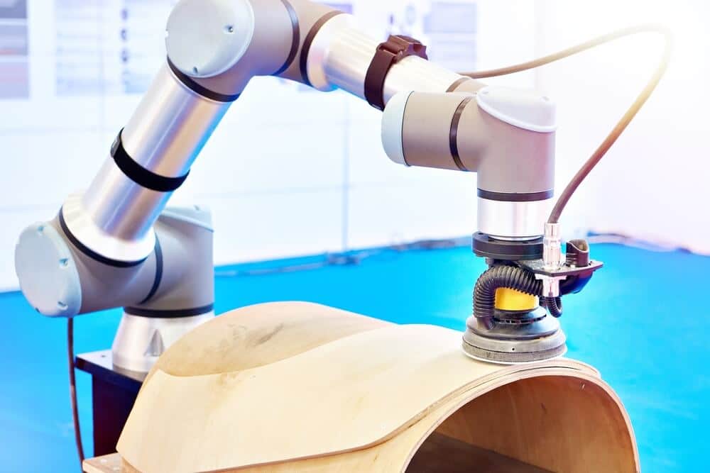 UR cobot performing wood grinding and sanding using vision-guided robotics for precise and automated woodworking processing.