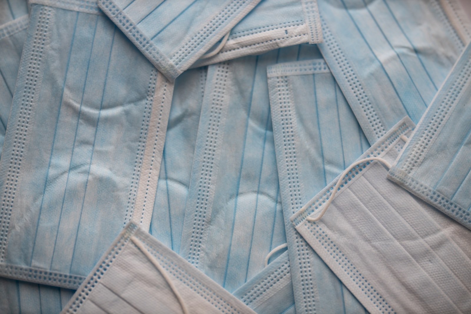 pile of blue surgical masks